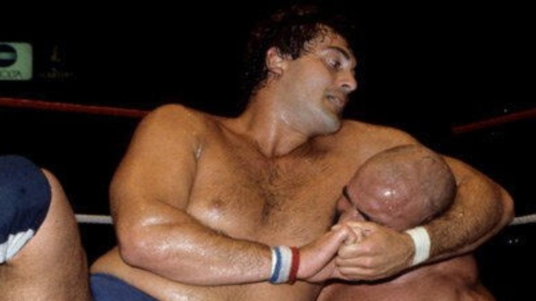 Mike Rotunda with a headlock on the Iron Sheik