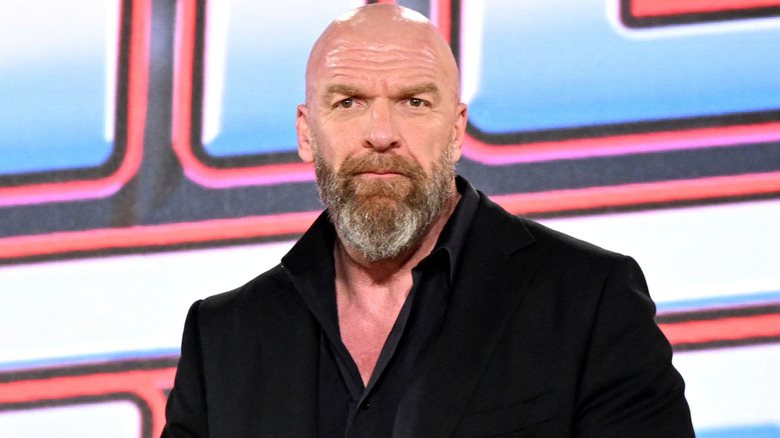 Triple H is wearing a black suit