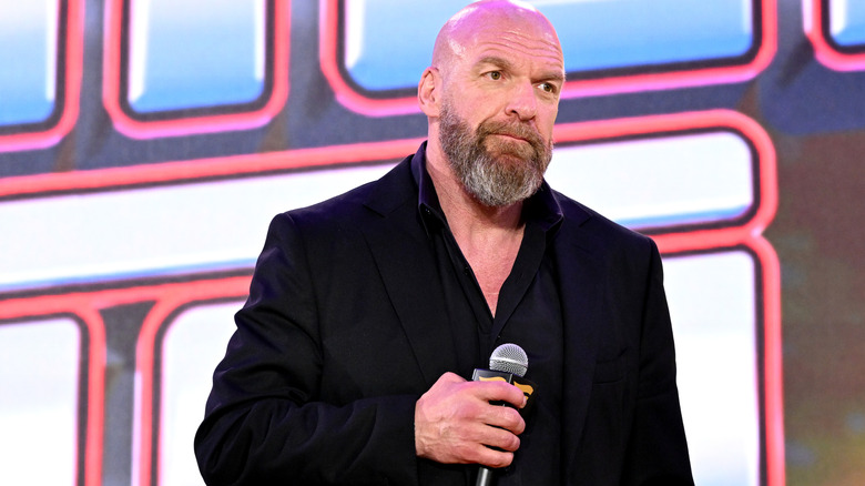 Paul Levesque with a microphone