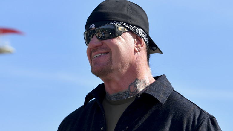 The Undertaker wearing a hat and sunglasses
