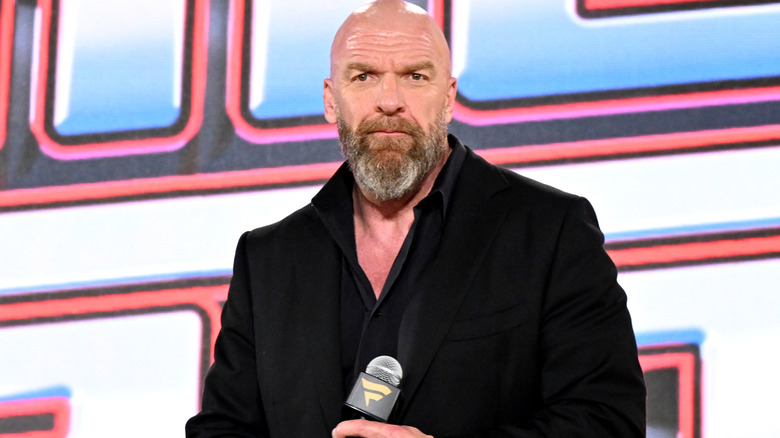 Triple H holding a microphone