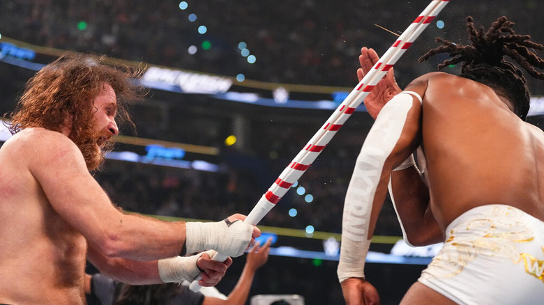 Sami Zayn hits Trick Williams with a kendo stick at WWE Backlash