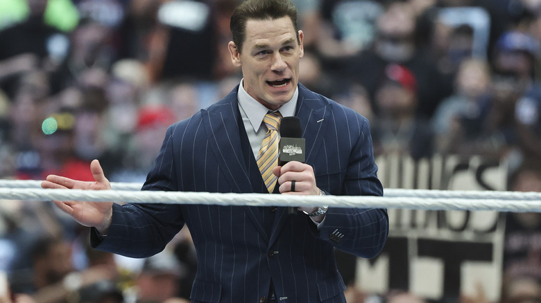 John Cena speaks into a microphone at WWE WrestleMania