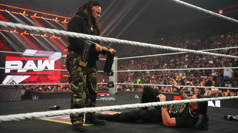 Jacob Fatu stands over Roman Reigns