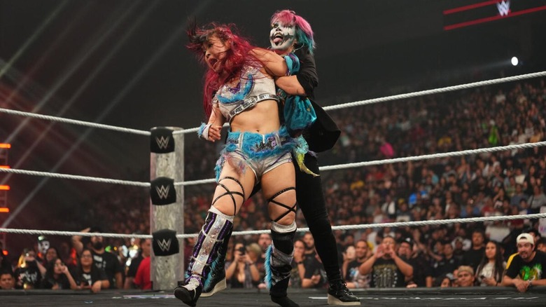 Asuka attacks IYO SKY from behind during a match on "WWE Raw."