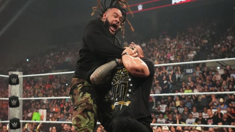 Jacob Fatu puts Roman Reigns in the Tongan Death Grip in the ring during an episode of 