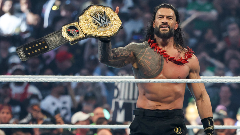 Reigns in the ring holding up his World Heavyweight Championship
