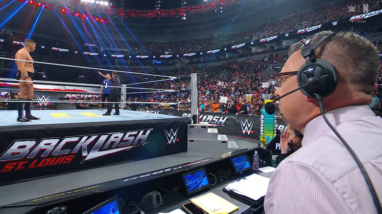 GUNTHER and McAfee in the ring as Cole watches on from the announce desk