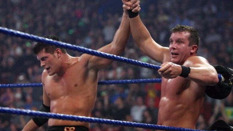 Cody Rhodes raises Ted DiBiase Jr.'s hand in the corner of the ring after they defeated D-Generation X at Breaking Point.