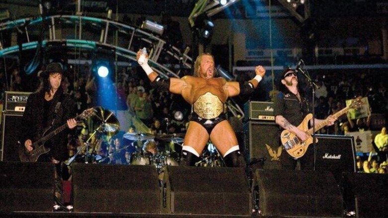 World Heavyweight Champion Triple H poses with Motorhead, as they perform his entrance music, before his match at WWE WrestleMania 21.