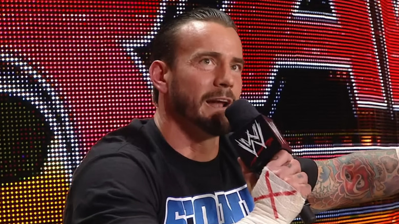 CM Punk speaking into a WWE microphone during 2011 pipe bomb promo