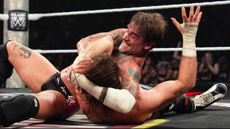 CM Punk attempts to lock in an Anaconda Vice on Sami Zayn