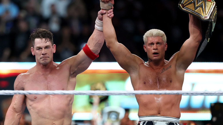 John Cena and Cody Rhodes celebrating after their match for the WWE Undisputed Championship, WWE SummerSlam 2025.
