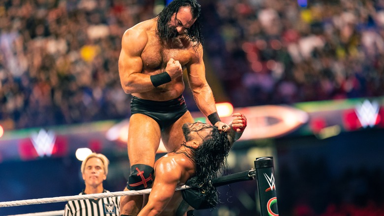Drew McIntyre fights Roman Reigns in the corner
