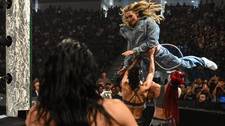 Charlotte Flair leaps onto B-Fab and Michin while Rhea Ripley looks on at WWE Clash in Italy 2026