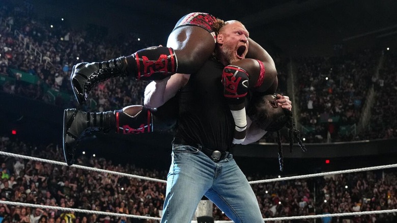 Brock Lesnar hoists Oba Femi up on his shoulders before hitting an F5 during an episode of "WWE Raw."