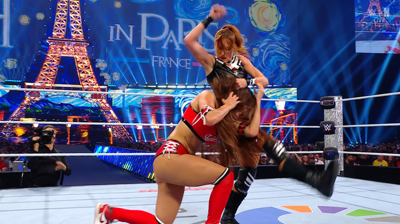 Lynch beating down Nikki in the ring