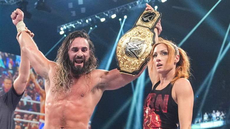 Seth Rollins celebrates in the ring with Becky Lynch at Clash in Paris