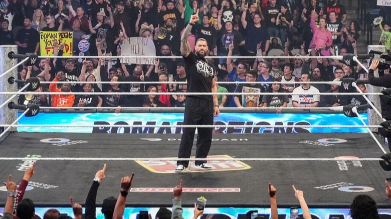 The fans follow Roman Reigns' lead by throwing up their 