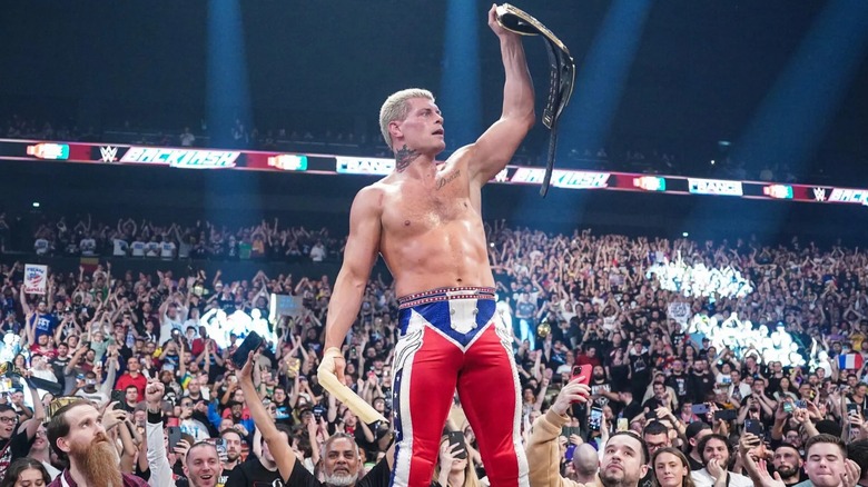 Cody Rhodes stands with the fans after a successful Undisputed WWE Championship title defense