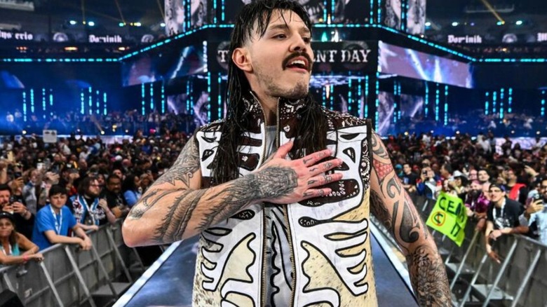 Dominik Mysterio poses on the stage ahead of a match on WWE progrmaming.