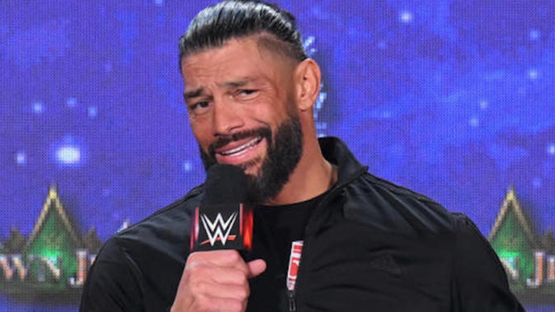 Roman Reigns sneering with microphone