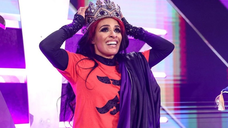 Zelina Vega puts the crown on her head on the stage of the Crown Jewel set after winning the Queen's Crown final against Doudrop.
