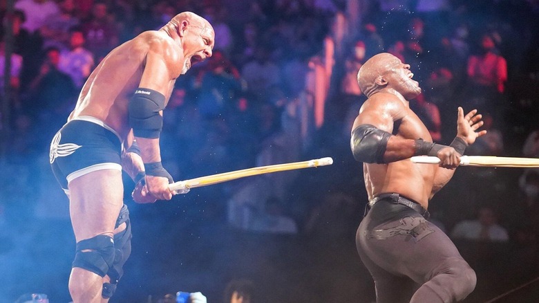 Goldberg hits Bobby Lashley across his back with a kendo stage on the ramp during their No Holds Barred match at Crown Jewel 2021.