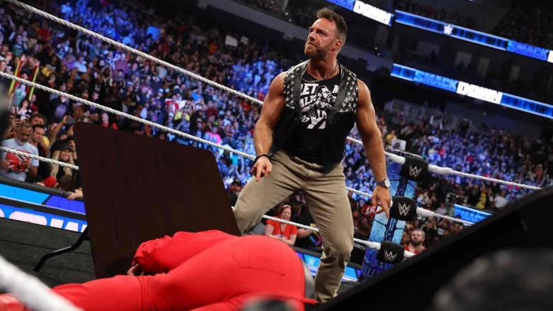 LA Knight stands over a broken table and Jimmy Uso after a contract signing on an episode of "WWE SmackDown."