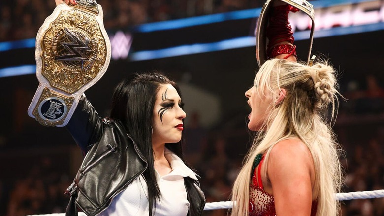 Stephanie Vaquer an Tiffany Stratton hold up their championships and stare each other down in the middle of the ring following Stratton's win on "WWE SmackDown."