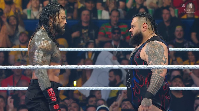 Reigns and Reed staring one another down