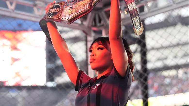 WWE referee Daphanie LaShaunn (Aja Smith) holds up the WWE United States Championship ahead of its defense