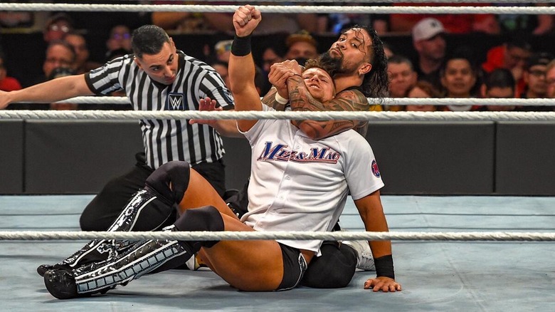 Jimmy Uso with a sleeper hold on The Miz at WWE Elimination Chamber 2019