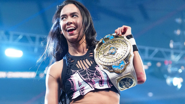 AJ Lee poses with the Women's Intercontinental Championship at WWE Elimination Chamber