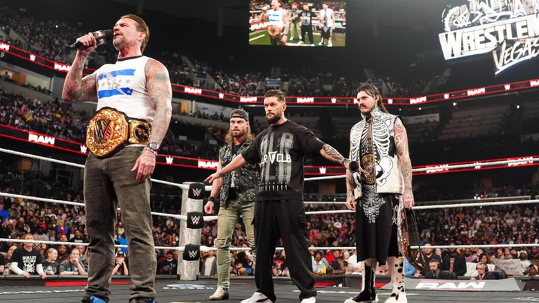 Finn Balor stands behind World Heavyweight Champion CM Punk and holds back Judgment Day stablemates JD McDonagh and Dominik Mysterio during an episode of 