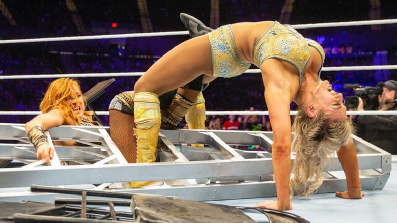 Charlotte Flair uses a ladder to help with a Figure 8 on Becky Lynch at WWE Evolution 2018