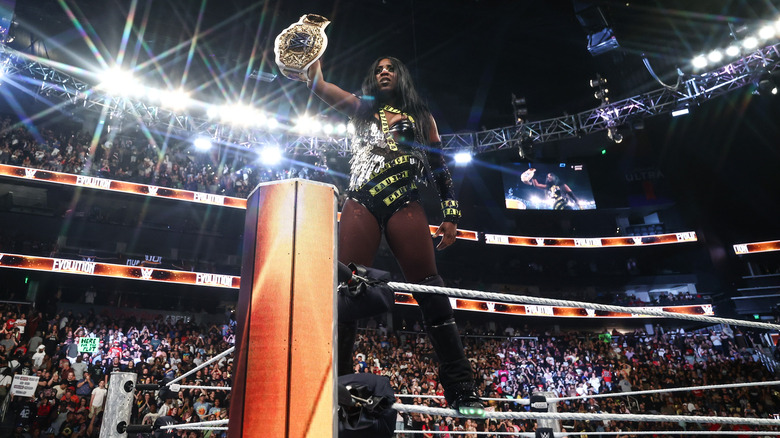 Naomi holds up Women's World Championship at WWE Evolution