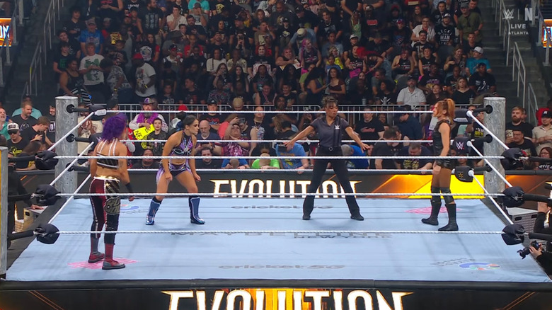 The three women staring each other down in the ring