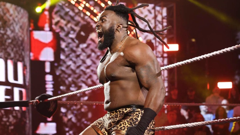 Keanu Carver stands on the ring apron and yells to the crowd before a match on 