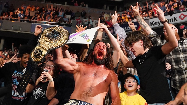 Seth Rollins celebrates with the fans