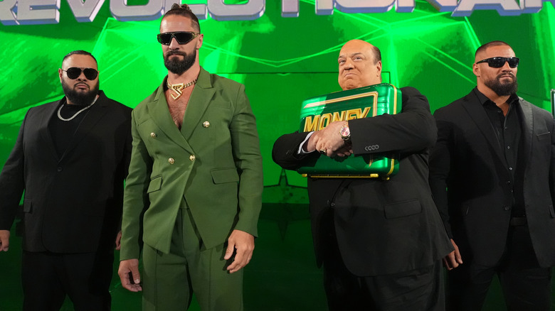 Bronson Reed, Seth Rollins, Paul Heyman, and Bron Breakker standing