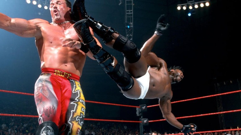 Booker T hits a dropkick on Buff Bagwell