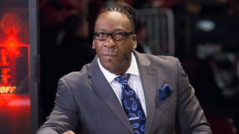 Booker T wearing a grey suit