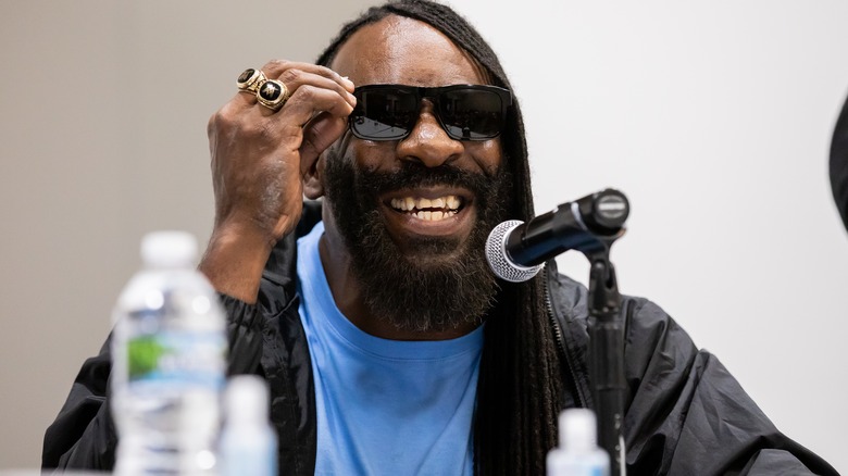 Booker T wearing black sunglasses and smiling