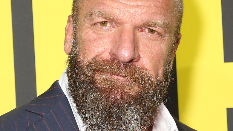 Triple H smiles at a press event