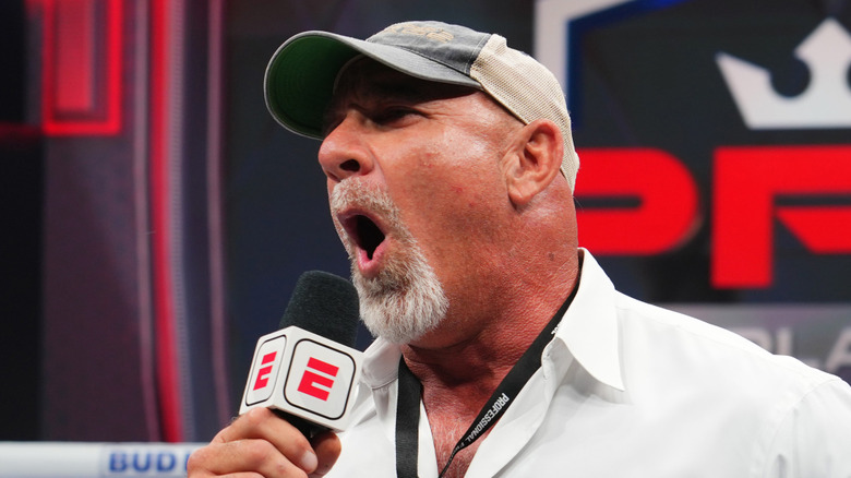 Bill Goldberg holding a microphone