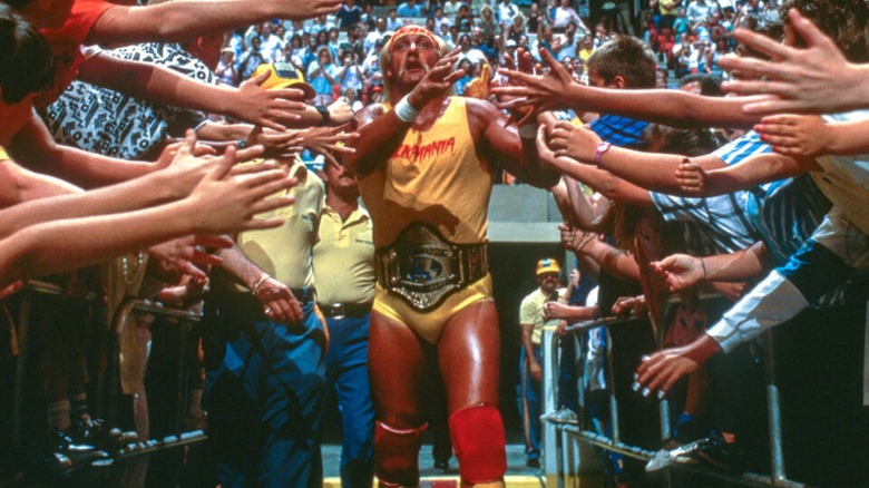 Hulk Hogan making his way to the ring while being welcomed by the crowd, 1980s.