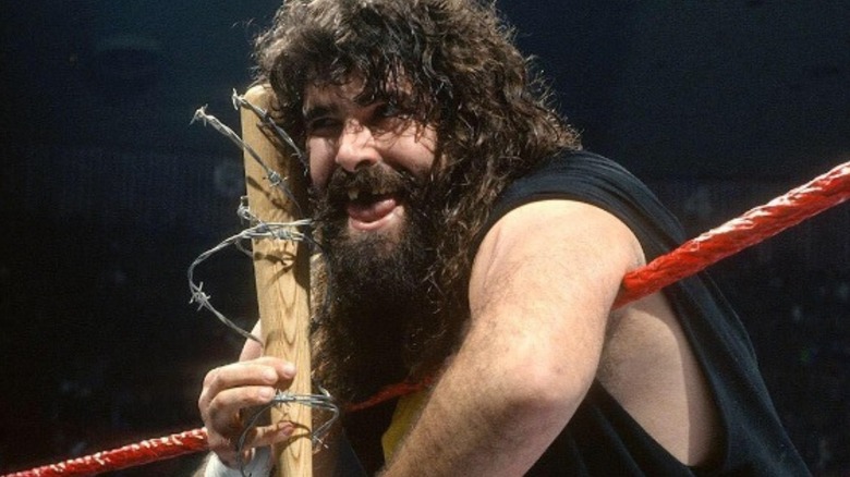Mick Foley stands in the ring