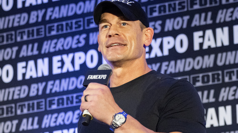 John Cena is holding a microphone