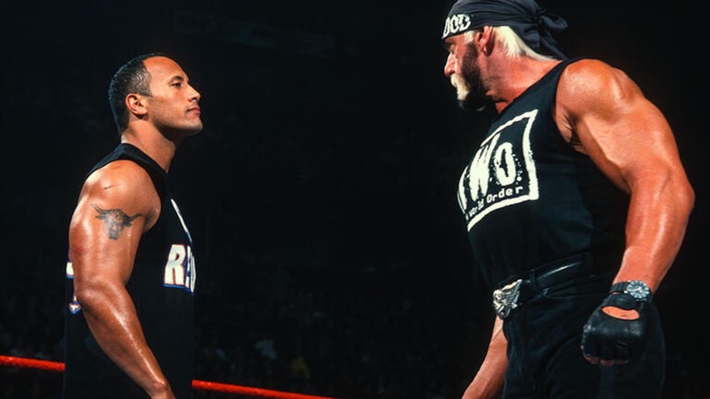 The Rock and Hulk Hogan stare each other down.